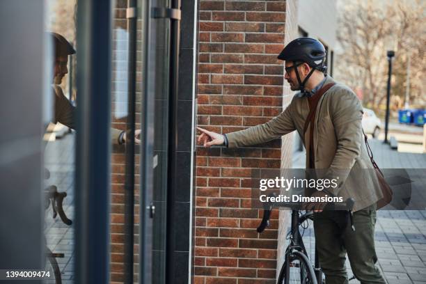 businessman ringing a door bell - intercom stock pictures, royalty-free photos & images