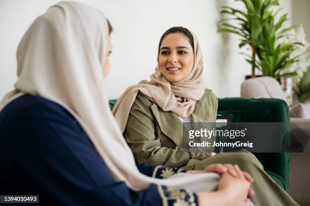 middle eastern women conversing in riyadh family home - arab family happy stock pictures, royalty-free photos & images