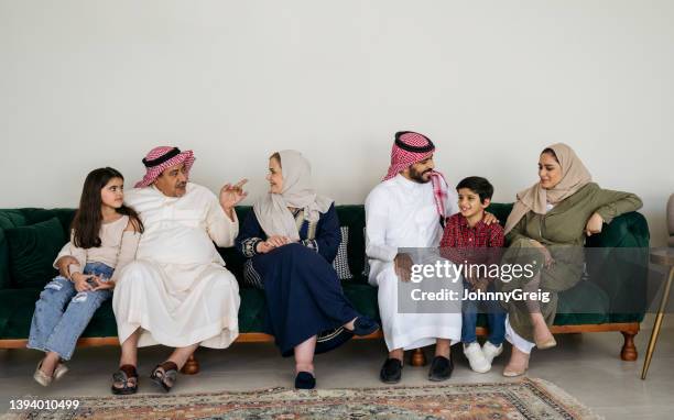 saudi family members interacting at home - saudi home stock pictures, royalty-free photos & images