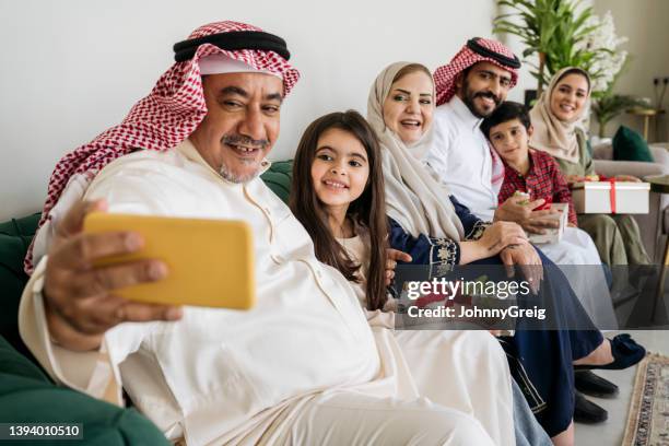 riyadh family taking selfie during eid al-fitr celebration - saudiarabien bildbanksfoton och bilder