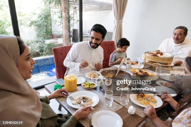 riyadh family talking and laughing as they enjoy lunch - saudi home stock pictures, royalty-free photos & images