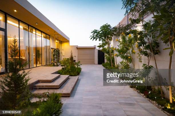 home exterior at dusk in riyadh, saudi arabia - landscaped stock pictures, royalty-free photos & images