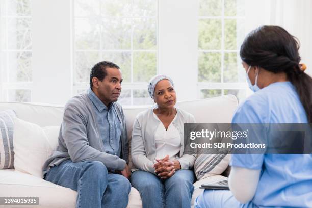 concerned couple listen to the nurse - hospice bildbanksfoton och bilder