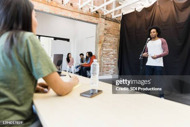 man gives improv performance for panel of judges - audition bildbanksfoton och bilder