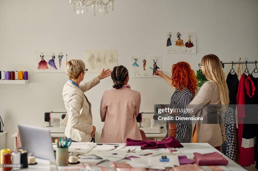 Four female coworkers working on their fashion design