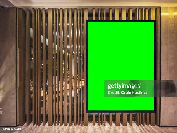 medium to large  size green screen chroma key marketing advertisement billboard in city centre shopping mall, train bus station, luxury hotel or airport environment targeting adverts at consumers, retail shoppers, commuters and tourists. - market retail space stock pictures, royalty-free photos & images