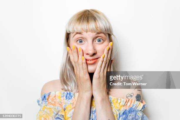 portrait of blond woman with hands on cheeks - head and shoulders fotografías e imágenes de stock