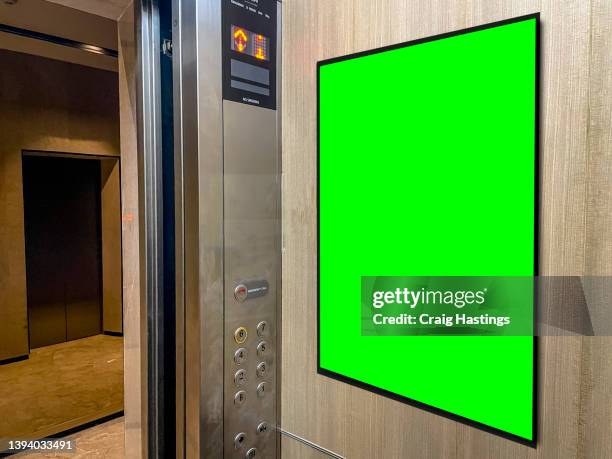 medium size green screen chroma key marketing advertisement billboard in airport, shopping mall or hotel elevator environment targeting adverts at consumers, shoppers, commuters, passenger and tourists - elevator fotografías e imágenes de stock