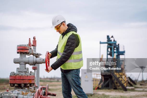 stationary or technical oil and gas manager at work, checking valve pipes, turn off on gas pump vent. - natural gas stock pictures, royalty-free photos & images