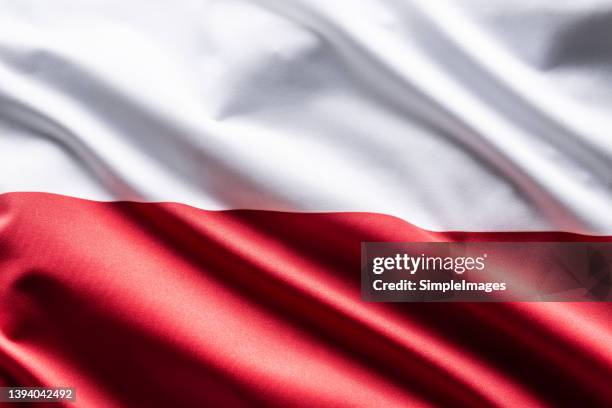 poland flag blowing in the wind. - polonia fotografías e imágenes de stock