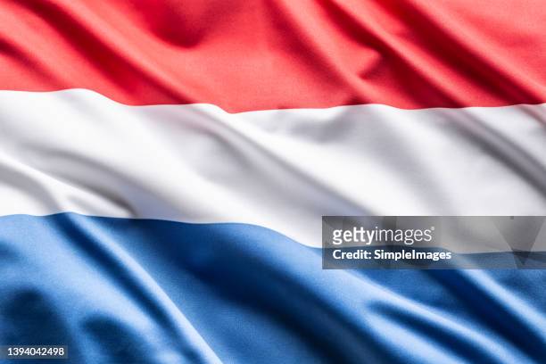 the luxembourg flag blows in the wind. - luxemburgs flagga bildbanksfoton och bilder