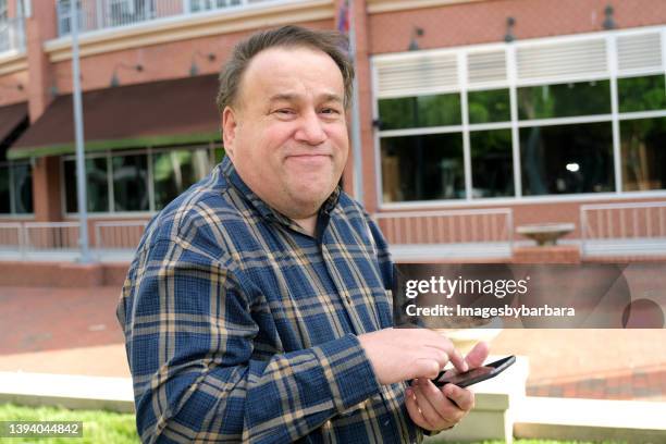 autistic man using a mobile phone - autism adult stock pictures, royalty-free photos & images