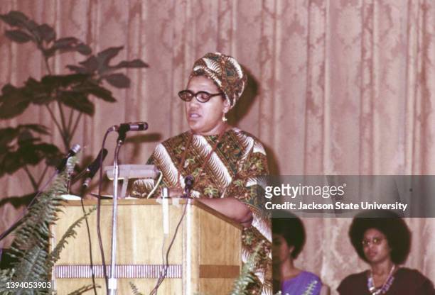 Audre Lorde giving speech at an event with Alice Walker behind.