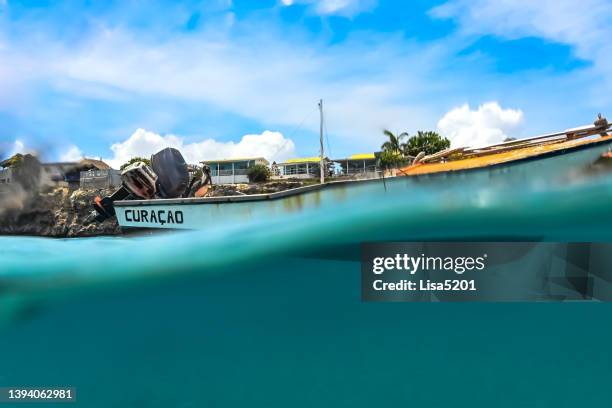 fishing boats floating in the lagoon in curaçao, scenic turquoise water and nautical vessels - curaçao stock pictures, royalty-free photos & images