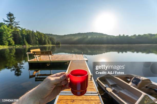 having coffee by a fishing lake during sunrise. - long weekend canada stock pictures, royalty-free photos & images