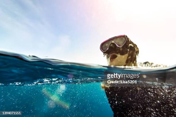 girl swimming in idyllic  caribbean sea take a breath above water - diving equipment stock pictures, royalty-free photos & images