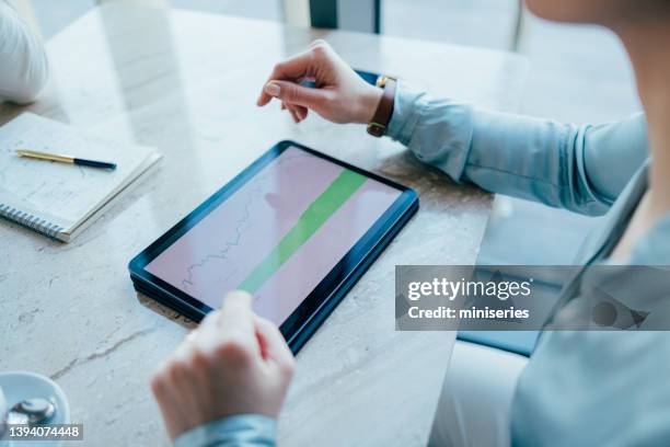 anonymous woman explaining a graph from her tablet (copy space) - zoom in office stock pictures, royalty-free photos & images