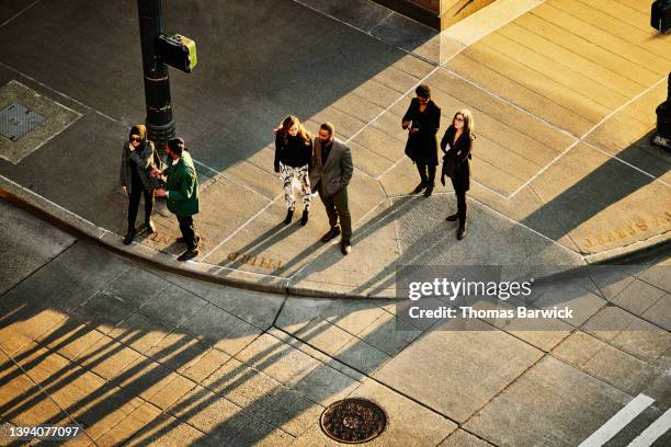 wide shot overhead view of business people waiting to cross street - high angle view walking stock pictures, royalty-free photos & images