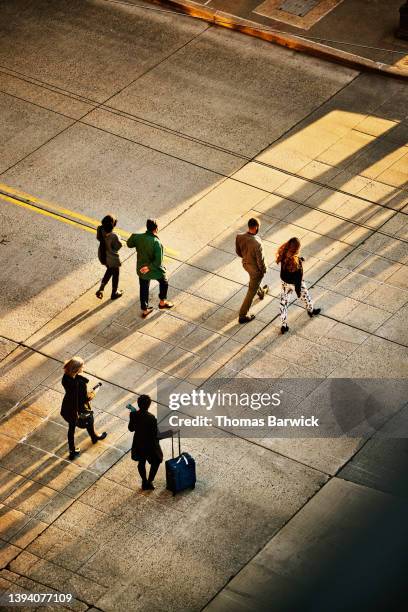 wide shot overhead view of business people crossing city street - commuters overhead view stock pictures, royalty-free photos & images