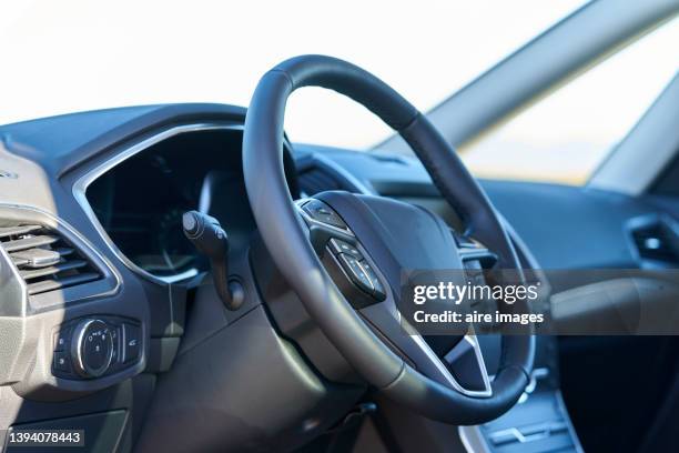 view of steering wheel and control panel vehicle interior at sunlight day - krockkudde bildbanksfoton och bilder