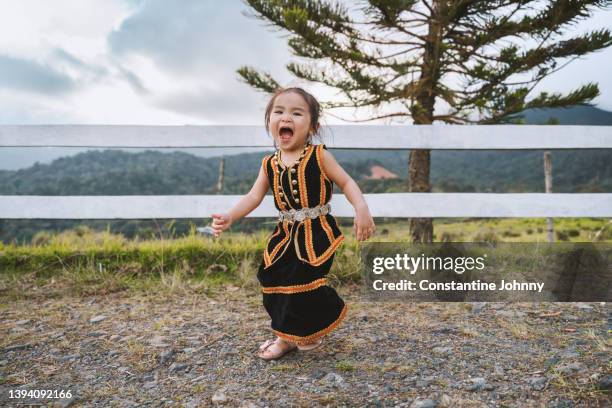 happy little toddler girl wearing kadazan dusun traditional costume - east malaysia stock pictures, royalty-free photos & images