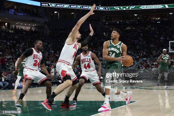 Giannis Antetokounmpo of the Milwaukee Bucks drives to the basket against Nikola Vucevic of the Chicago Bulls in the third quarter during Game Five...