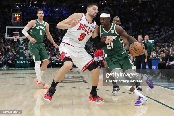 Jrue Holiday of the Milwaukee Bucks is defended by Nikola Vucevic of the Chicago Bulls during the second half of Game Five of the Eastern Conference...