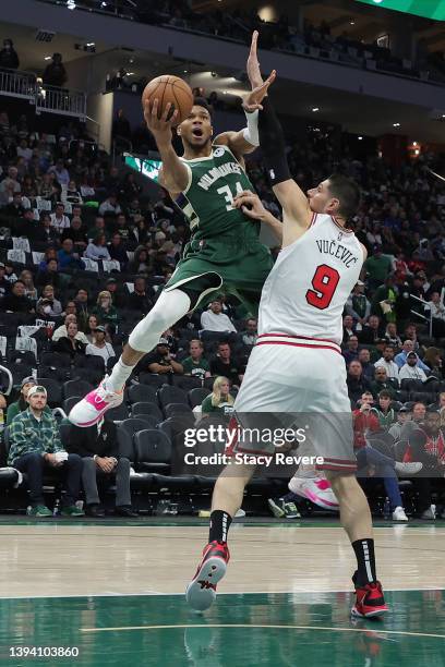 Giannis Antetokounmpo of the Milwaukee Bucks drives to the basket against Nikola Vucevic of the Chicago Bulls during the second half of Game Five of...