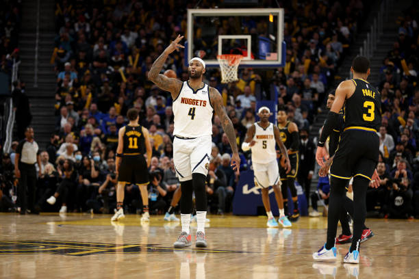 DeMarcus Cousins of the Denver Nuggets reacts after he made a three-point basket against the Golden State Warriors at the end of the third quarter...