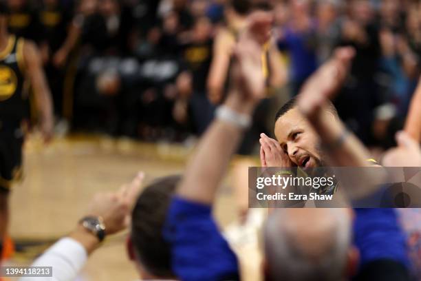 Stephen Curry of the Golden State Warriors reacts after he made a basket over Monte Morris of the Denver Nuggets in the final minute of during Game...