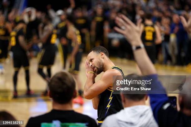 Stephen Curry of the Golden State Warriors reacts after he made a basket over Monte Morris of the Denver Nuggets in the final minute of during Game...