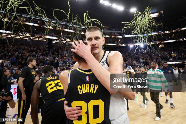 Stephen Curry of the Golden State Warriors hugs Nikola Jokic of the Denver Nuggets after Game Five of the Western Conference First Round NBA Playoffs...