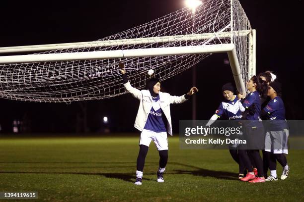 Melbourne Victory Afghan Women’s Team carry the goal back to the side of the pitch at the completion of a Melbourne Victory Afghan Women's Team...