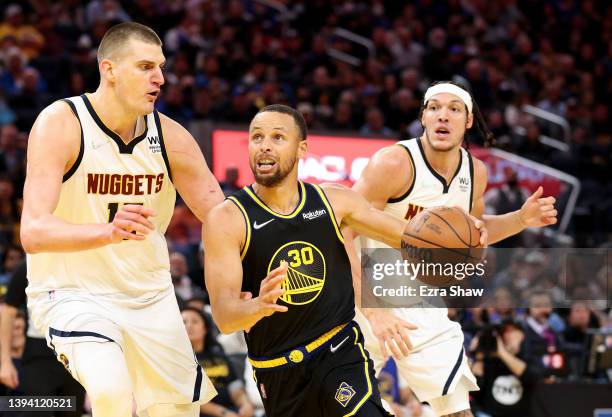 Stephen Curry of the Golden State Warriors is guarded by Nikola Jokic of the Denver Nuggets in the second half during Game Five of the Western...