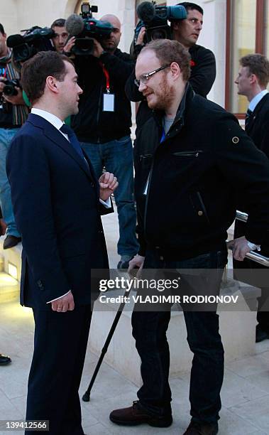 Russian President Dmitry Medvedev speaks with Oleg Kashin, a reporter with Russian newspaper Kommersant, who was brutally beaten in November 2010, in...