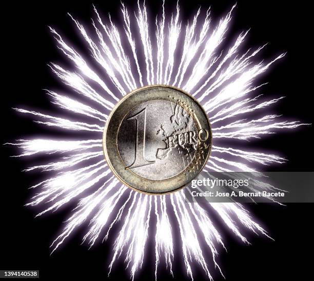 one euro coin with electric lightning explosion. - tax reform stock-fotos und bilder