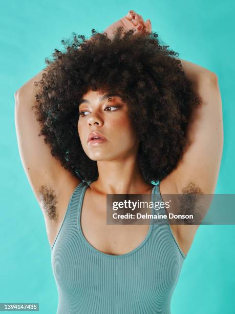 mixed race woman showing armpit hair in the studio - young hairy pics 個照片及圖片檔