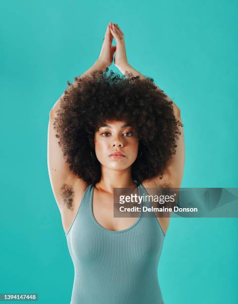 mixed race woman showing armpit hair in the studio - hairy women imagens e fotografias de stock