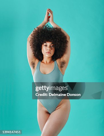 Mixed race woman showing armpit hair in the studio Mixed race woman showing armpit hair in the studio