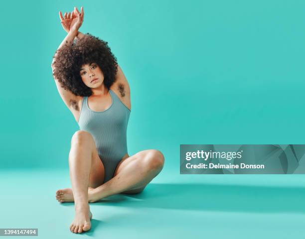 full body mixed race model sitting and showing armpit hair in studio - cabeludo imagens e fotografias de stock