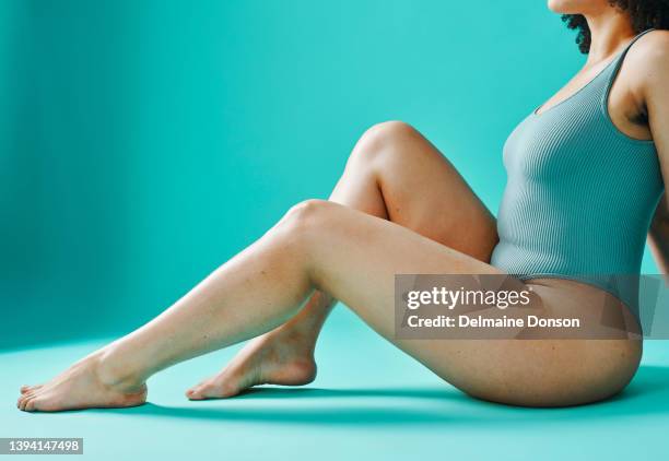 unknown mixed race model showing legs in the studio - hairy woman stockfoto's en -beelden