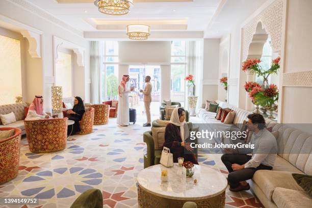 riyadh hotel guests enjoying conversation in tea lounge - saudi relaxing stock pictures, royalty-free photos & images