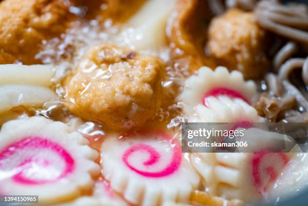 close-up japanese food oden meatball boiled in an iron pot with steam rising. - dikon radish stock pictures, royalty-free photos & images