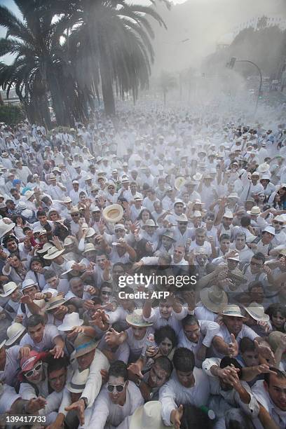 People throw talcum powder at one another as they take part in the carnival "Los Indianos" in Santa Cruz de la Palma, on the Spanish Canary island of...