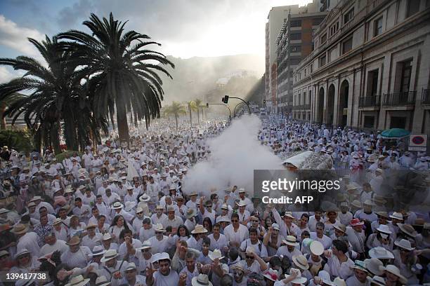 People throw talcum powder at one another as they take part in the carnival "Los Indianos" in Santa Cruz de la Palma, on the Spanish Canary island of...