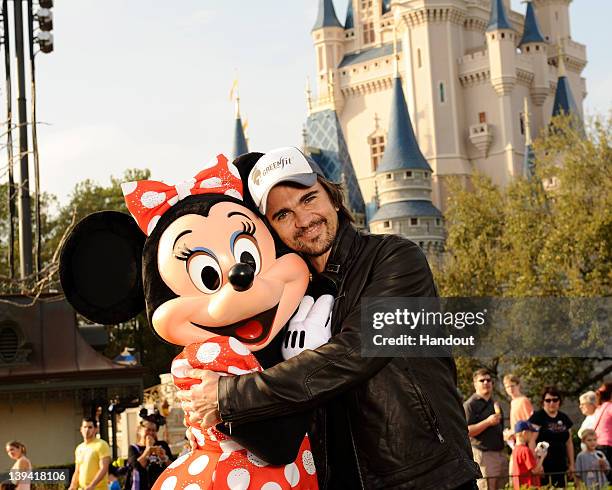 In this handout image provided by Disney Parks, GRAMMY Award- and seventeen-time Latin GRAMMY Award-winning singer/songwriter Juanes receives a...