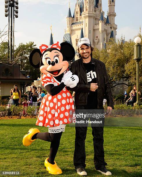 In this handout image provided by Disney Parks, GRAMMY Award- and seventeen-time Latin GRAMMY Award-winning singer/songwriter Juanes receives a...
