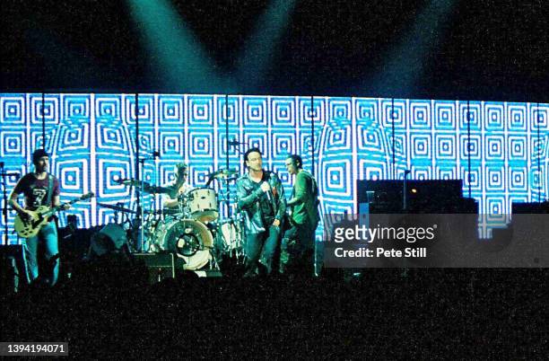Guitarist The Edge, drummer Larry Mullen Jr, singer Bono and bass-player Adam Clayton of Irish rock band U2 perform on stage in concert at Earls...