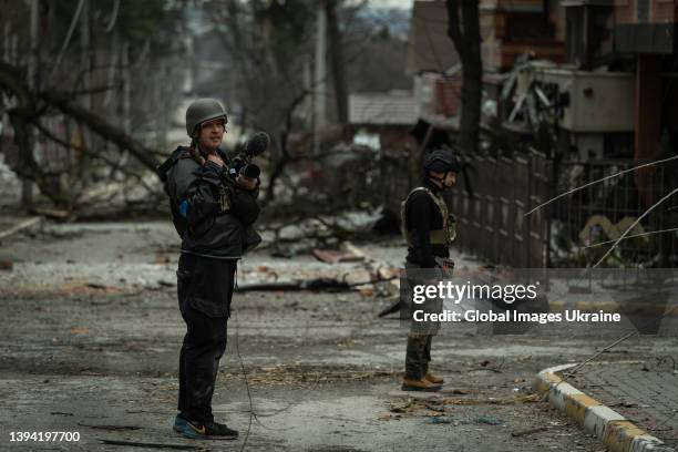 Photojournalist stands close to a Ukrainian serviceman on the street on March 29 in Irpin, Ukraine. The Ukrainian army liberated the city of Irpin,...