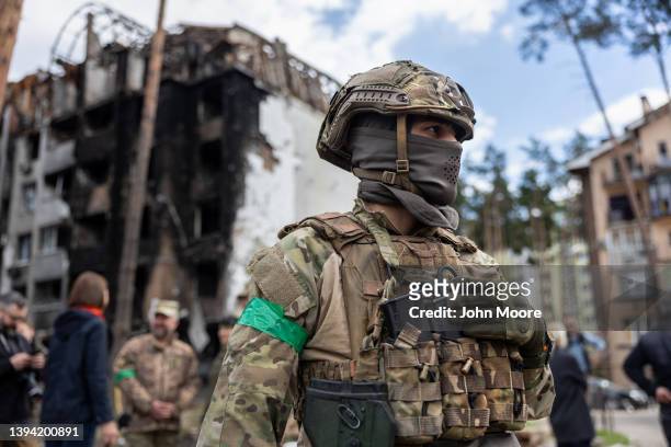 Ukrainian army soldier stands guard at the war damaged Irpinsky Lipky residential complex following the visit of United Nations Secretary-General...